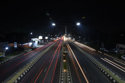 High angle view of light trails on highway at night