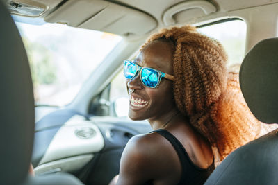 Happy young woman in a car