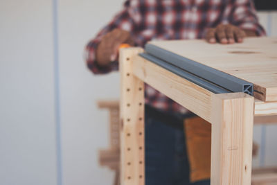 Close-up of man playing piano on table