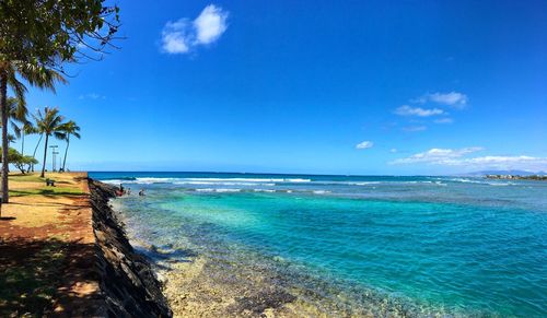 Scenic view of sea against blue sky