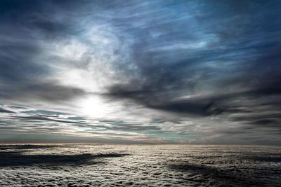 Scenic view of sea against cloudy sky