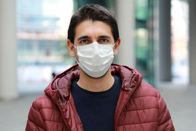 Portrait of mid adult man wearing mask standing outdoors