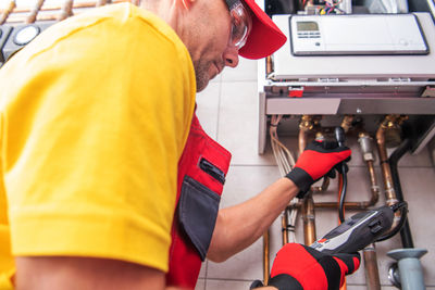 Rear view of man working in workshop