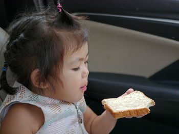 Close-up portrait of cute girl eating food