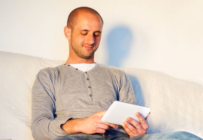 Midsection of man using mobile phone