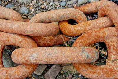 High angle view of rusty chain on field