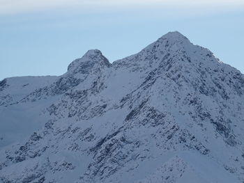 Scenic view of snowcapped mountains against clear sky