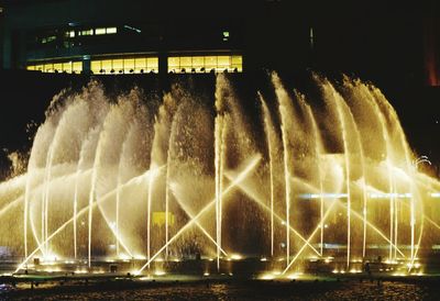 Illuminated ferris wheel at night