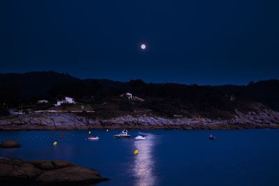 Scenic view of sea against clear sky at night