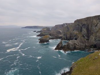 Scenic view of sea and mountains against sky