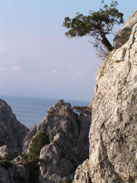 Rock formations by sea against sky