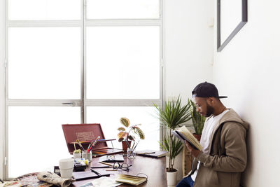 Side view of illustrator working at creative office