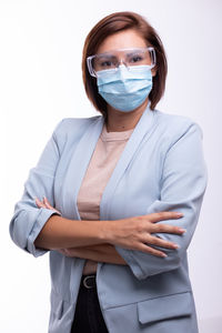 Midsection of woman standing against white background