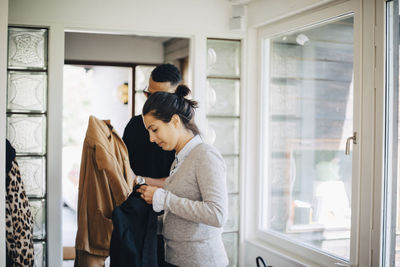 Woman looking through window