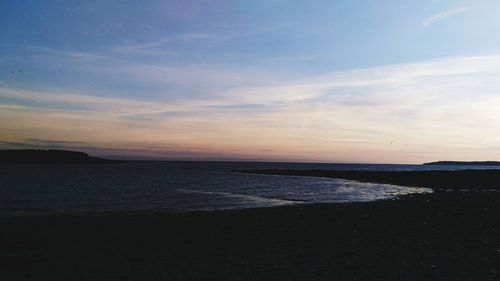 Scenic view of sea against sky at sunset