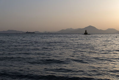 Scenic view of sea against clear sky during sunset