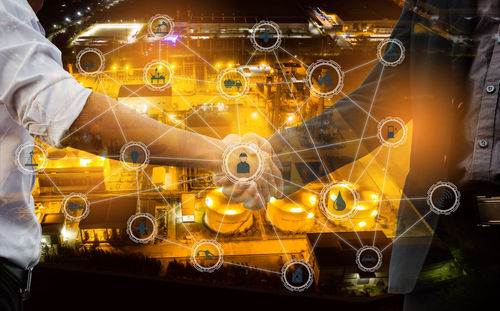 Person holding illuminated lighting equipment at night