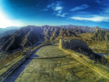 Road leading towards mountains against sky