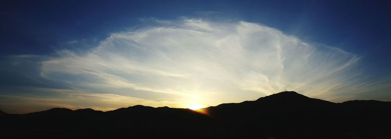 Scenic view of silhouette mountains against sky during sunset
