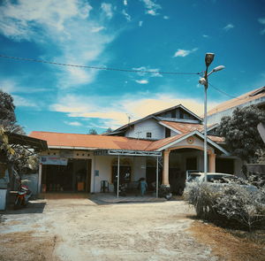 Houses by street against sky in city