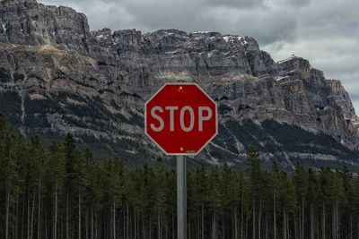 Low angle view of road sign against sky