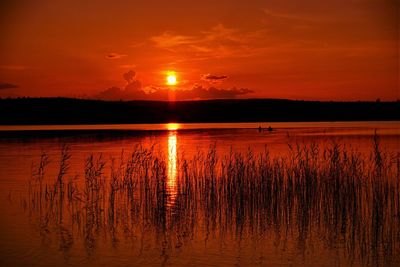 Scenic view of lake against romantic sky at sunset