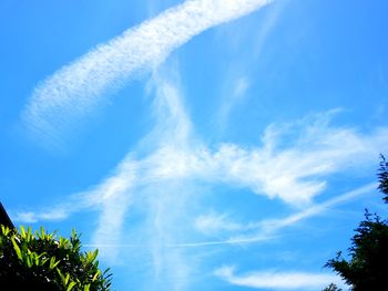 Low angle view of vapor trail against blue sky