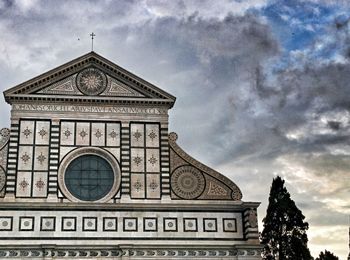 Low angle view of building against cloudy sky