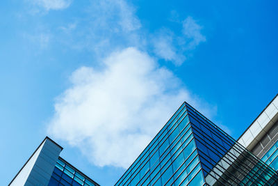 Low angle view of modern building against blue sky