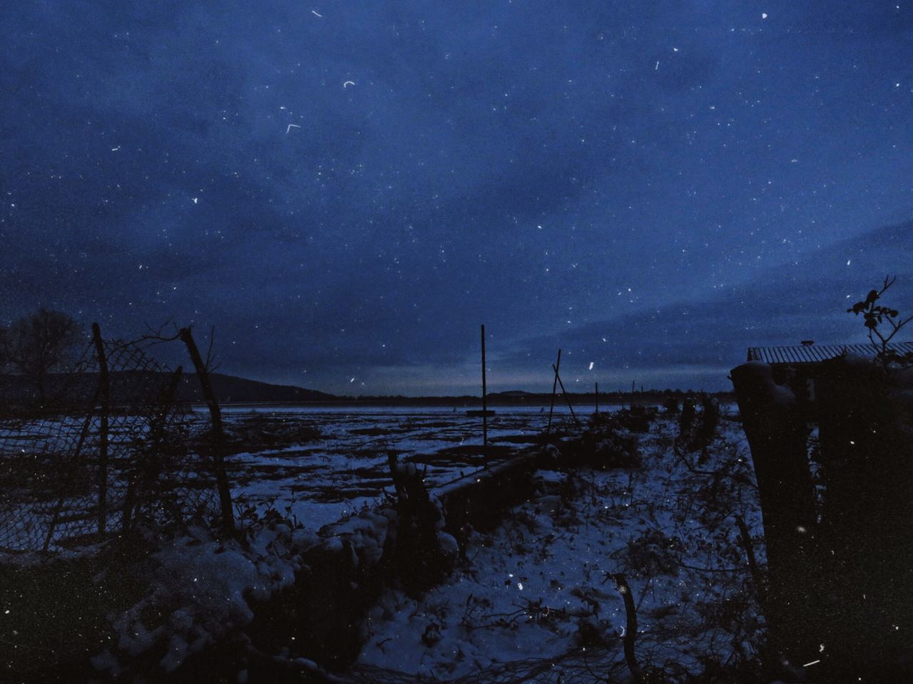 sky, snow, cold temperature, night, scenics - nature, beauty in nature, winter, tranquility, nature, tranquil scene, no people, star - space, land, space, water, astronomy, environment, outdoors, dusk