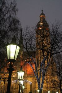 Low angle view of illuminated street light against sky at dusk