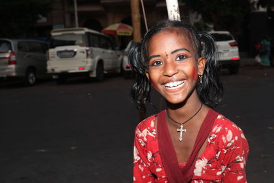 Portrait of young woman standing on street