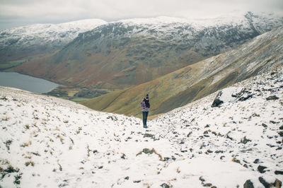 Tourists on snow covered mountain