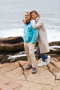 Middle age couple standing and hugging and smiling