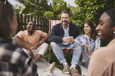 Friends sitting together in garden