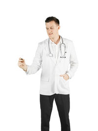 Doctor gesturing while standing against white background