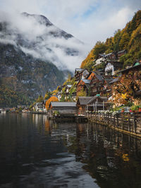 Scenic view of lake by mountains against sky