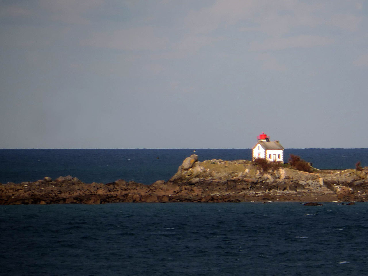 LIGHTHOUSE AMIDST SEA AGAINST SKY