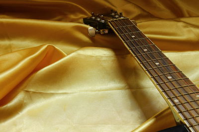 Close-up of guitar on fabric