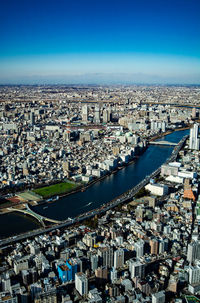 High angle view of cityscape against blue sky