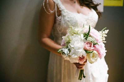 Midsection of woman holding flower bouquet