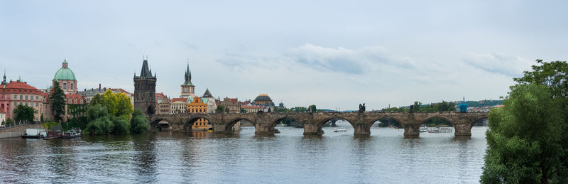 Panoramic shot of charles bridge over river vltava against sky