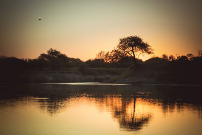 Scenic view of lake against sky during sunset