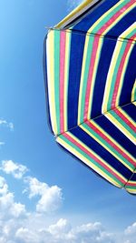 Low angle view of colorful balloons against blue sky