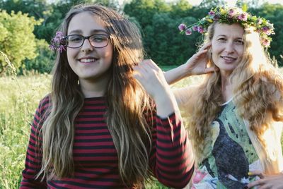 Portrait of woman and daughter standing outdoors