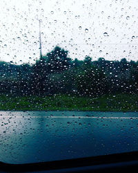 Close-up of wet glass window in rainy season