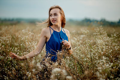 Portrait of beautiful young woman on land