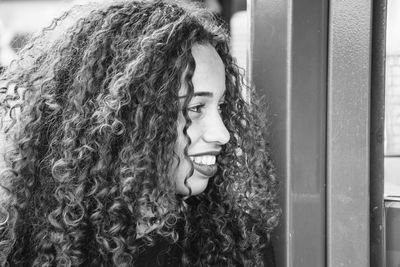 Close-up of young woman with curly hair