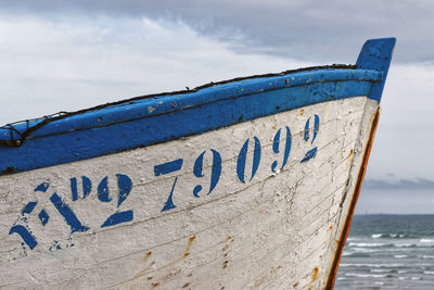 Text on beach against blue sky