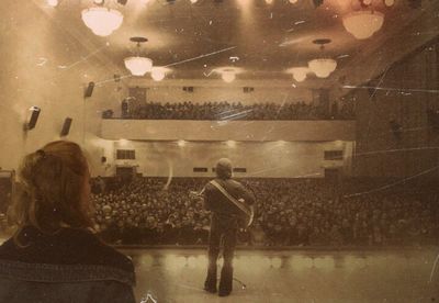 Rear view of people standing on glass